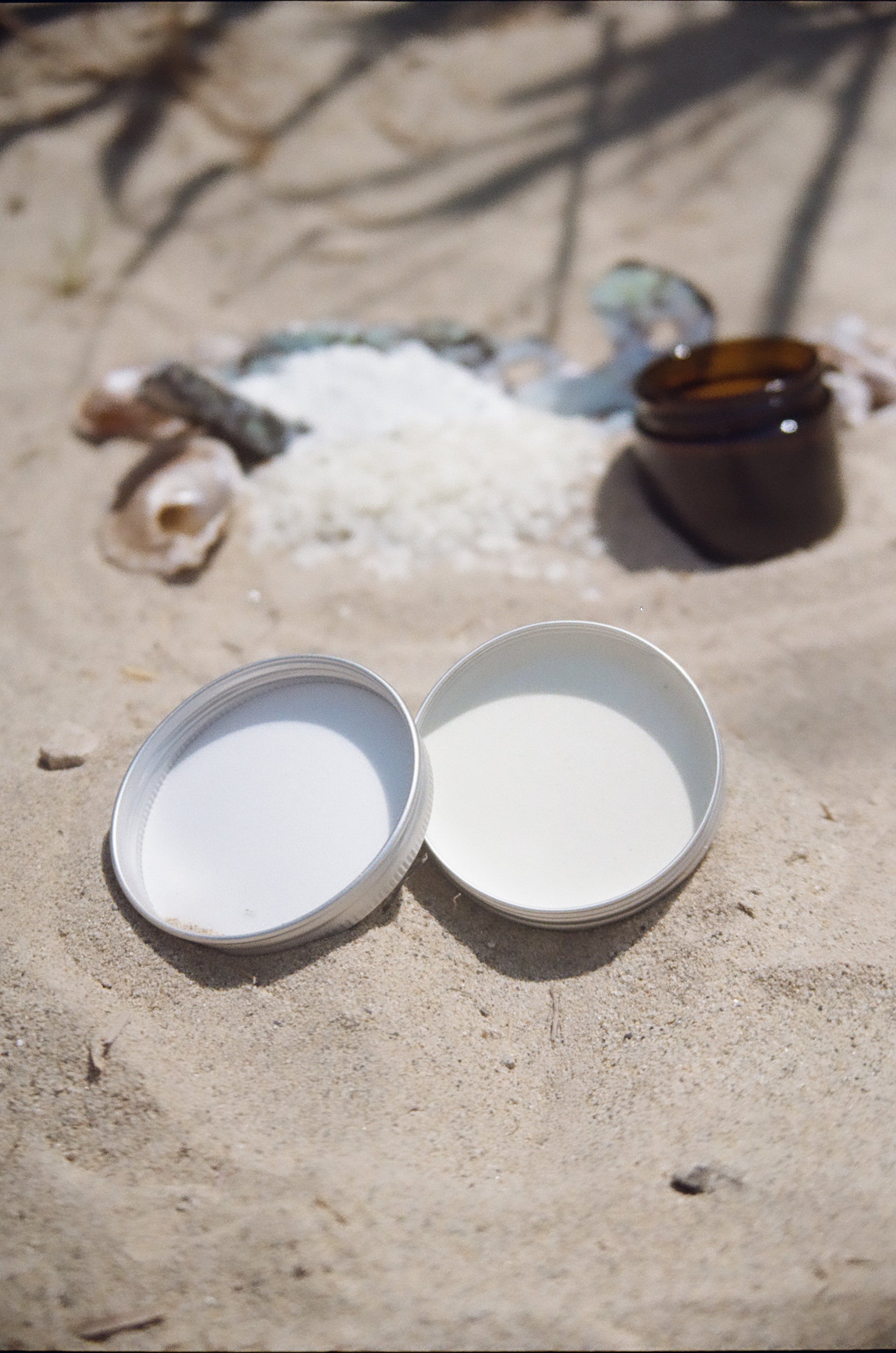 Open Seaker Sun Co mineral sun balm tin on sand with zinc oxide and natural ingredients — safe, non-toxic mineral sunscreen for kids and sensitive skin